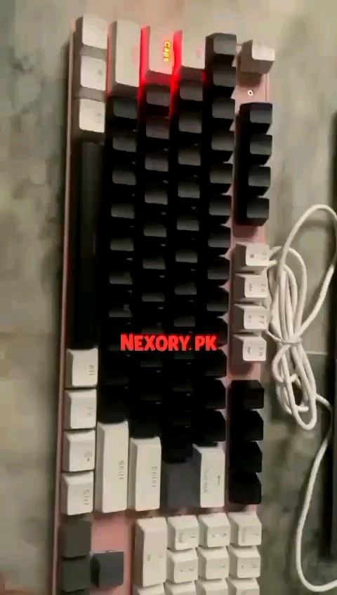 87-Key Mechanical Keyboard With Black And White Keys And Pink Backplate